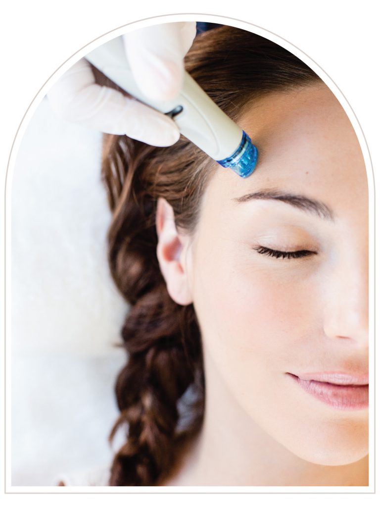 Woman receiving a Hydrafacial treatment with a handheld device for deep cleansing and skin hydration